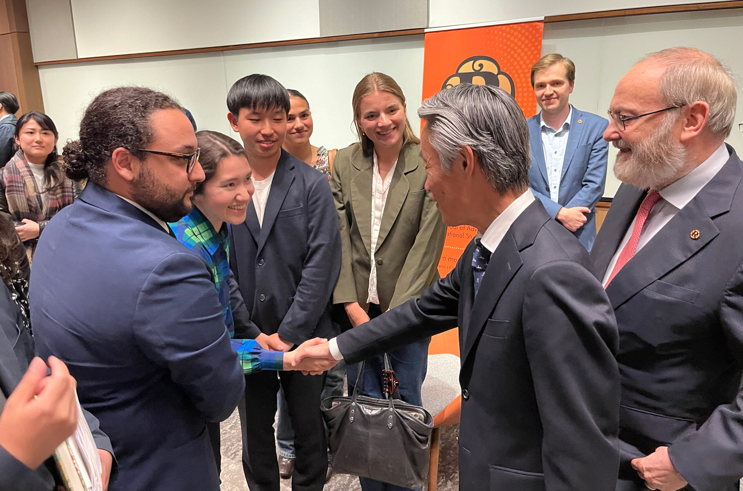 Japan ambassador Shigeo Yamada shakes hands with a small group of people