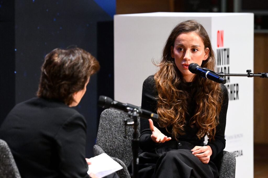 A close-up of two people conversing on a stage