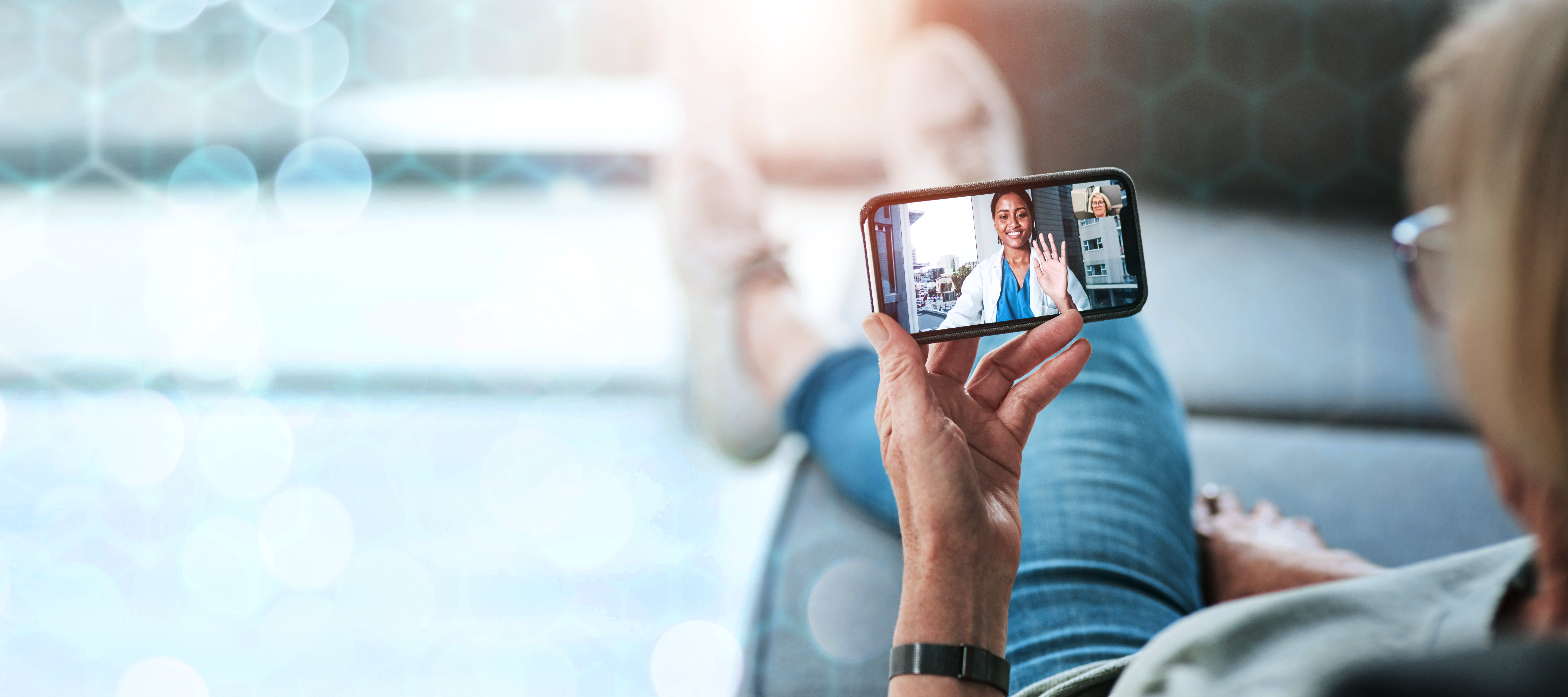 Telemedicine concept with doctor on smartphone speaking with unseen patient