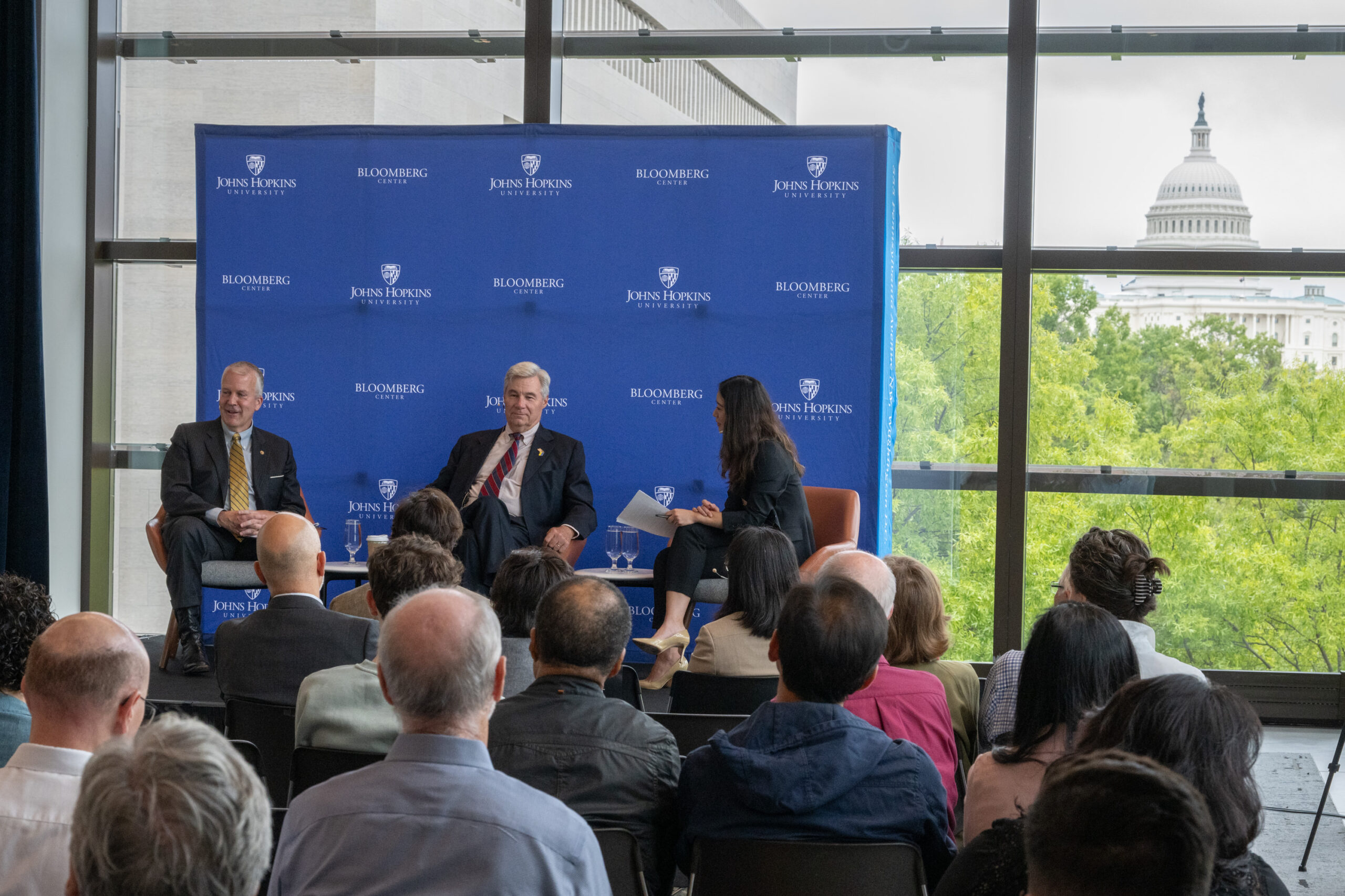 Sens. Dan Sullivan and Sheldon Whitehouse address a small, seated crowd